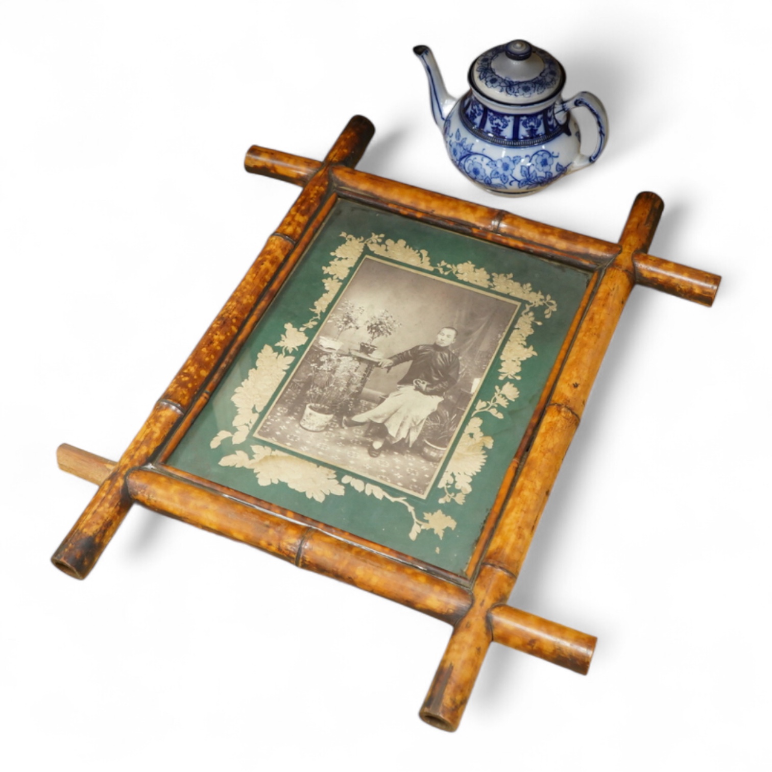 A MacIntyre Burslem blue and white teapot, c.1900, 15cm high and an early 20th century Chinese portrait photograph in a bamboo frame